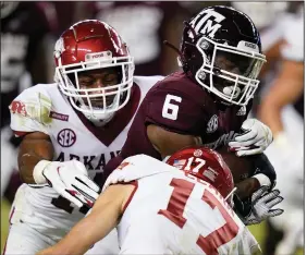  ?? (AP/Sam Craft) ?? Texas A&M running back Devon Achane (6) broke free from the Arkansas defense for a 30-yard touchdown run Saturday night. Three Razorbacks had chances to bring down Achane on the run, which was the Aggies’ final score of the game.