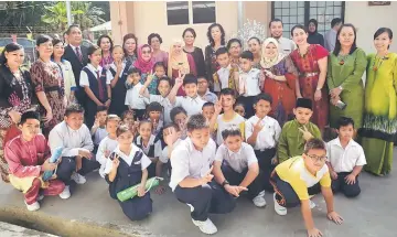  ??  ?? Juma’ani (standing 6th left, first row) posing with teachers and pupils of Kelas Pendidikan Khas of SK Kampung Baru.