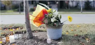  ?? Leah Hennel/Calgary Herald ?? A memorial is placed outside the home in Chaparral where Carmel Christians was stabbed to death.