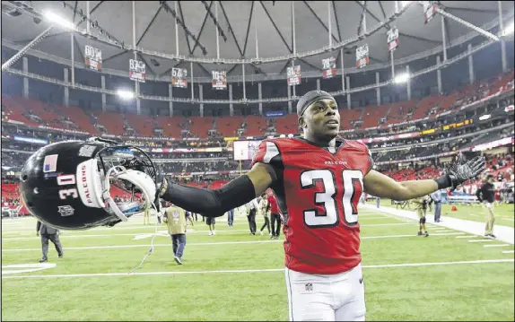  ?? CURTIS COMPTON / CCOMPTON@AJC.COM ?? Falcons cornerback Deji Olatoye celebrates Atlanta’s 38-32 victory Sunday over the Saints. The Falcons’ offense reigned, but the defense had a little trouble near the end containing Saints quarterbac­k Drew Brees, who came alive in the fourth quarter.