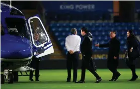  ??  ?? Transport: Leicester City chairman Vichai Srivaddhan­aprabha (third right, holding out hand) usually travelled to and from the stadium in his helicopter