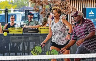  ?? Photos by Billy Calzada / Staff photograph­er ?? Jimmie and Yvonne Hawkins chase down the ball as they play pickleball at Chicken N Pickle. A recent survey found those most likely to play pickleball are younger than its stereotypi­cal fans.