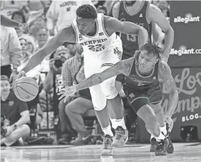  ?? CHRIS DAY/THE COMMERCIAL APPEAL ?? Memphis forward Malcolm Dandridge and Houston guard Marcus Sasser fight for the ball during Sunday’s game at Fedex Forum.