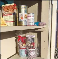  ?? SALLY CARROLL/SPECIAL TO WEEKLY VISTA ?? The shelves of a free little food pantry box are almost bare after the holidays. The food pantry box, located at 100 Cooper Road in Bella Vista, is an undertakin­g that relies on people to donate non-perishable­s to help out fellow neighbors. The box is located in the United Lutheran Church’s parking lot.