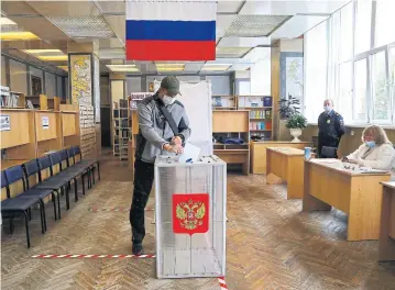  ?? AFP ?? A man casts his ballot in a nationwide vote on constituti­onal reforms at a polling station in Vladivosto­k yesterday.