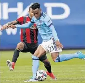  ?? KATHY WILLENS/ASSOCIATED PRESS ?? Atlanta United’s Tyrone Mears (2) defends against New York City FC forward Rodney Wallace (23) on Sunday.