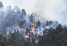  ?? AP photo / RJ Sangosti, The Denver Post ?? The Kruger Rock fire continues to burn southeast of downtown Estes Park, Colo., on Tuesday. A wildfire in the town that serves as a gateway to Rocky Mountain National Park has prompted some residents and businesses to be evacuated.