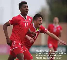  ??  ?? Malta’s Paul Mbong (L) wheels away in celebratio­n after scoring the first for Malta against Gibraltar