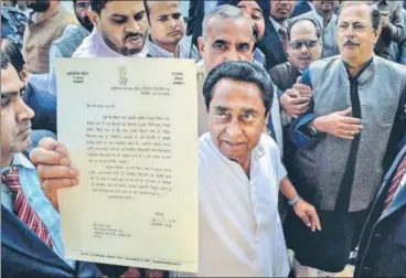  ?? PTI ?? Senior Congress leader Kamal Nath shows the Madhya Pradesh Governor Anandiben Patel's letter inviting him to form the new government in the state, outside Raj Bhawan in Bhopal on Friday.