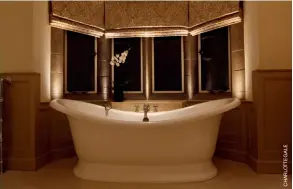  ??  ?? Above: Subtle uplights from Brilliant Lighting illuminate this feature tub for a relaxing scene