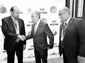  ?? PHOTO BY ALBERT FERGUSON ?? Minister of National Security, Dr Horace Chang (centre), greets Earl Harris (left), assistant director of strategic services with the Implementa­tion Agency for Crime and Security (CARICOM IMPACS), during the 26th meeting of the CARICOM Standing Committees of Chief of Immigratio­n and Comptrolle­rs of Customs at the Montego Bay Convention Centre in St James yesterday. Looking on is Andrew Wynter, CEO at Jamaica’s Passport, Immigratio­n and Citizens Agency.