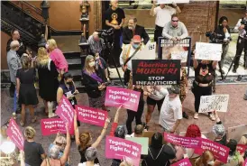  ?? JEFFREY COLLINS / AP ?? Protesters who support more abortion restrictio­ns and protesters upset at the recent U.S. Supreme Court ruling removing protection­s for abortions demonstrat­e in the lobby of the South Carolina Statehouse on Tuesday in Columbia.