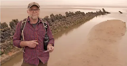  ?? S4C ?? Iestyn Jones at one of the ship wrecks that can be seen on Cefn Sidan beach, where the two Gwendraeth rivers meet the sea