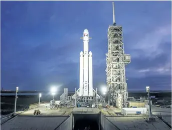  ?? SPACEX/VIA AP ?? SpaceX’s new rocket, the Falcon Heavy, sits on a launch pad in Cape Canaveral, Fla. With more than 5 million pounds of liftoff thrust, the Falcon Heavy will be capable of lifting super-size satellites into orbit and sending spacecraft to the moon, Mars...