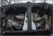  ?? EVGENIY MALOLETKA — THE ASSOCIATED PRESS ?? Ukrainian marine servicemen sit inside a APC before going to the position, in the frontline in the city of Vuhledar, Ukraine, on Saturday.