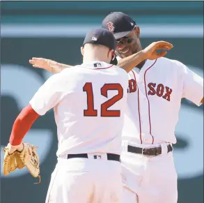  ?? Steven Senne / Associated Press ?? Brock Holt (12) celebrates with Xander Bogaerts, right, after they beat the Blue Jays in Boston on Sunday.