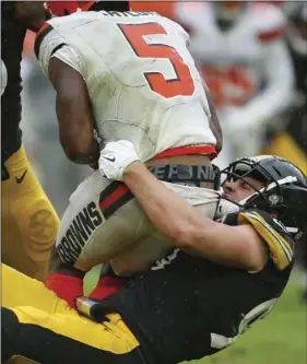  ??  ?? Pittsburgh Steelers linebacker T.J. Watt (90) sacks Cleveland Browns quarterbac­k Tyrod Taylor (5) during the second half of an NFL football game, on Sept. 9, in Cleveland. AP PHOTO/RON SCHWANE