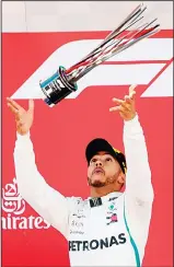  ??  ?? Mercedes’ British driver and first place winner Lewis Hamilton celebrates on the podium after the Spanish Formula One Grand Prix at the Circuit de Catalunya in Montmelo in the outskirts of Barcelona on May 13.
(AFP)