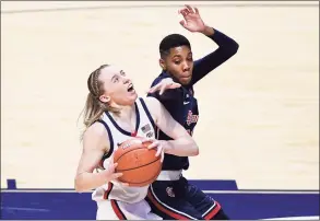  ?? Jessica Hill / Associated Press ?? UConn’s Paige Bueckers, left, looks to shoot while pressured by St. John’s Kadaja Bailey during the first half of the Big East tournament quarterfin­als at Mohegan Sun Arena on Saturday in Uncasville.
