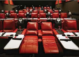  ?? CHRIS WALKER / CHICAGO TRIBUNE ?? Reclining theater seats with pivoting dining trays are among the amenities in AMC’s Dine-In Theatre at Block 37 in downtown Chicago. AMC says theaters with recliners have seen a 40- to 60-percent rise in attendance.