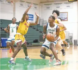  ?? HANNAH RUHOFF/STAFF ?? Green Run’s George Wilson, center, prepares to shoot against Bayside on Jan. 29. Both teams are in this week’s Class 5 Region A tournament.