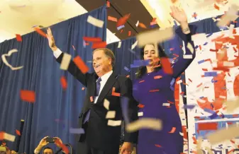  ?? John Bazemore / Associated Press ?? Senate candidate Doug Jones and his wife, Louise, wave to their supporters at an election-night party in Birmingham, Ala. He’ll be the first Democratic senator from Alabama since 1997.