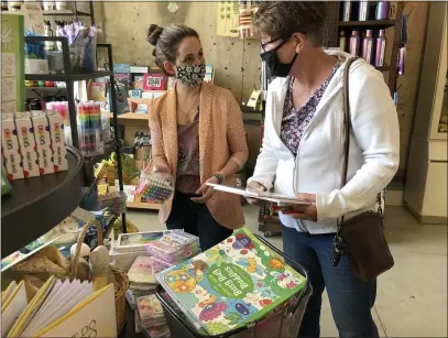  ?? KYRA GOTTESMAN — MERCURY-REGISTER ?? Bernadette North, left, of Kusel’s Big Store assists Rosie Glaze with shopping for Easter gifts for her grandchild­ren and great grandchild­ren on Tuesday. Kusel’s is just one of the stores extending its hours on Friday for April’s Downtown Oroville First Friday Spring Fling event.