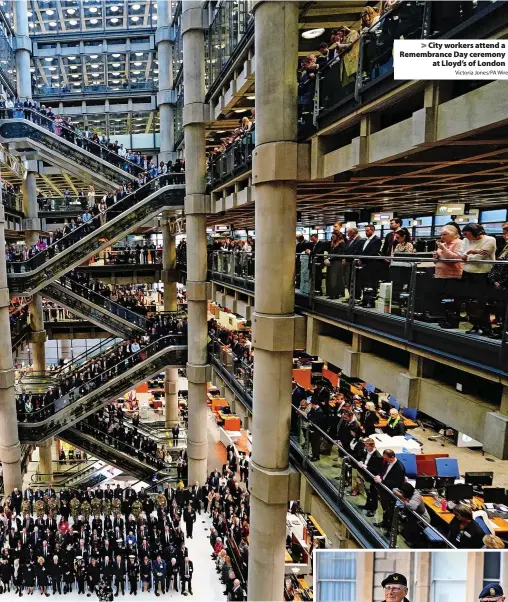  ?? Victoria Jones/PA Wire ?? > City workers attend a Remembranc­e Day ceremony at Lloyd’s of London