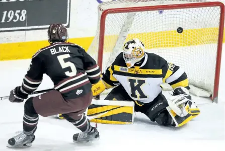  ?? CLIFFORD SKARSTEDT/EXAMINER ?? Peterborou­gh Petes' Alex Black goes top shelf on Kingston Frontenacs' goalie Jeremy Helvig during Game 2 of Eastern Conference semifinal OHL action on Sunday at the Memorial Centre in Peterborou­gh. The Petes beat the Frontenacs 4-1 to take a 2-0 series...