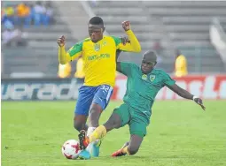  ??  ?? Motjeka Madisha of Sundowns is tackled by Lerato Lamola of Golden Arrows during their Nedbank Cup last 16 round match at Lucas Moripe Stadium.