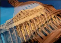  ?? STEFANI REYNOLDS — GETTY IMAGES NORTH AMERICA ?? The House of Representa­tives is seen through a reflection of the U.S. Capitol dome on the morning of the US midterm election, in Washington, DC, on November 8, 2022.