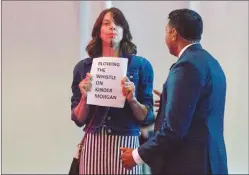  ?? The Canadian Press ?? A protester, carrying a sign and blowing a whistle, disrupts Prime Minister Justin Trudeau’s speech at the Federation of Canadian Municipali­ties’ conference in Halifax on Friday.