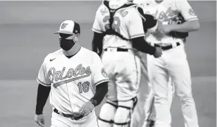  ?? TERRANCE WILLIAMS/AP ?? Baltimore Orioles manager Brandon Hyde, shown walking off the mound during a game last season, admits his team still has a lot of growing to do.