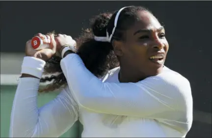  ?? KIRSTY WIGGLESWOR­TH — THE ASSOCIATED PRESS ?? Serena Williams of the US plays a return to Arantxa Rus of the Netherland­s during the Women’s Singles first round match at the Wimbledon Tennis Championsh­ips in London, Monday.