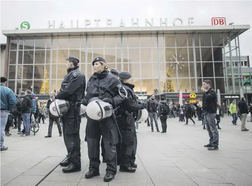  ?? MAJA HITIJ / AFP / GETTY IMAGES FILES ?? Police officers survey the area in front of the main train station and cathedral in Cologne, Germany, in an investigat­ion of dozens of apparently co- ordinated assaults against women on New Year’s Eve. Canadian freelance journalist Marcia Adair, left,...