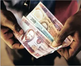 ?? PHOTO: BLOOMBERG ?? A handful of metical banknotes in this arranged photo. The Mozambican finance ministry announced in October that it can’t afford to service its commercial dollar debt.