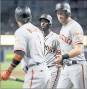  ?? KELVIN KUO — THE ASSOCIATED PRESS ?? Andrew McCutchen, center, celebrates with Evan Longoria, right, and Gregor Blanco after scoring on a two-run single by Hunter Pence during the first inning.