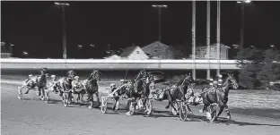  ?? JASON SIMMONDS • THE GUARDIAN ?? Time To Dance leads the field at the halfway mark of the 53rd running of the $25,000 Governor's Plate, presented by Summerside Chrysler Dodge, at Red Shores at Summerside Raceway on July 10.