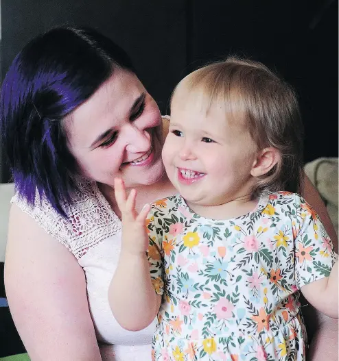  ?? NICK PROCAYLO/ PNG FILES ?? Charlie Lock, shown with her mother Bekah in this July photo before her second birthday, has porphyria, meaning she is allergic to the sun. The complicati­ons are many; she just received a liver transplant and will be getting a bonemarrow transplant as well.