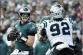  ?? MATT ROURKE — THE ASSOCIATED PRESS ?? Eagles quarterbac­k Carson Wentz looks to pass over Panthers defensive tackle Vernon Butler (92) during the first half Sunday.