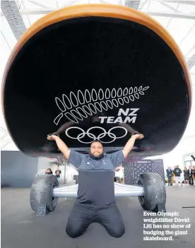  ??  ?? Even Olympic weightlift­er David Liti has no show of budging the giant skateboard.