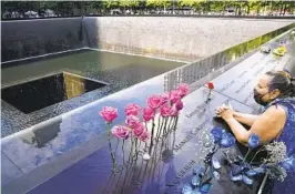  ?? JOHN MINCHILLO AP FILE ?? A mourner prays at the National September 11 Memorial and Museum in New York City on Sept. 11, 2020, the 19th anniversar­y of the terror attacks.