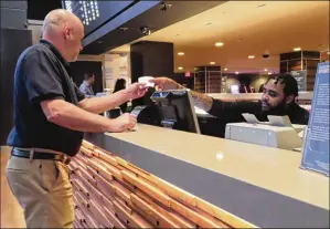  ?? AP ?? A customer receives a betting ticket at the Tropicana casino in Atlantic City Thursday. American gamblers have wagered over $125 billion on sports with legal betting outlets in the four years since the U.S. Supreme Court cleared the way for all 50 states to offer legal sports betting.