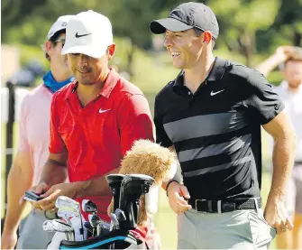  ??  ?? Happy to be back: Rory McIlroy, right, is all smiles during practice for the Charles Schwab Challenge tournament at the Colonial Country Club in Fort Worth, Texas, on Tuesday.