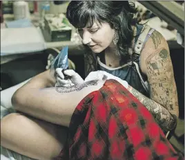  ?? SubmitteD ?? Alicia Vocke tattoos a client in preparatio­n for her upcoming event on Saturday.