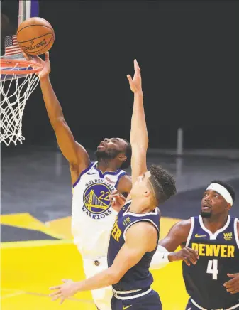  ?? Carlos Avila Gonzalez / The Chronicle ?? Andrew Wiggins ( 22) puts up a shot during the first half in Golden State’s preseasono­pening game against the Denver Nuggets, a twopoint victory in San Francisco.