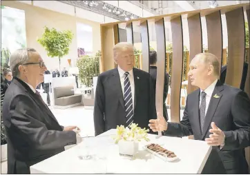  ?? STEFFEN KUGLER — VIA ASSOCIATED PRESS ?? European Commission President Jean-Claude Juncker, left, President Donald Trump and Russian President Vladimir Putin chat Friday before the first working session of the G-20summit in Hamburg, Germany.