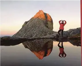  ??  ?? Posing at the mirror image lake at Low’s Peak.