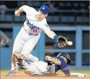  ?? Wally Skalij Los Angeles Times ?? DODGERS second baseman Logan Forsythe can’t get to the throw as Padres’ Manuel Margot steals second.