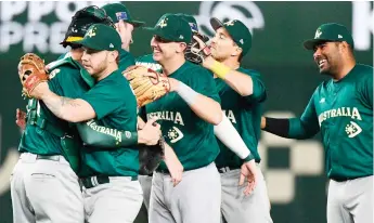  ?? — AFP photo ?? Australian players celebrate their 8-3 victory to advance after the Pool B encounter with Czech Republic at the Tokyo Dome.